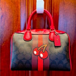 Coach PAC-MAN Signature Cherry small satchel cross body bag. FI657-F56650